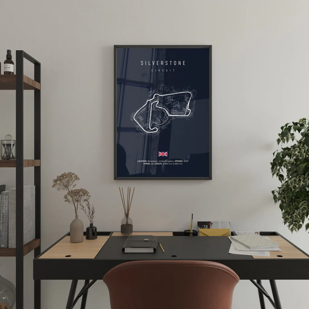 Framed map of Silverstone Circuit on a wall above a desk.