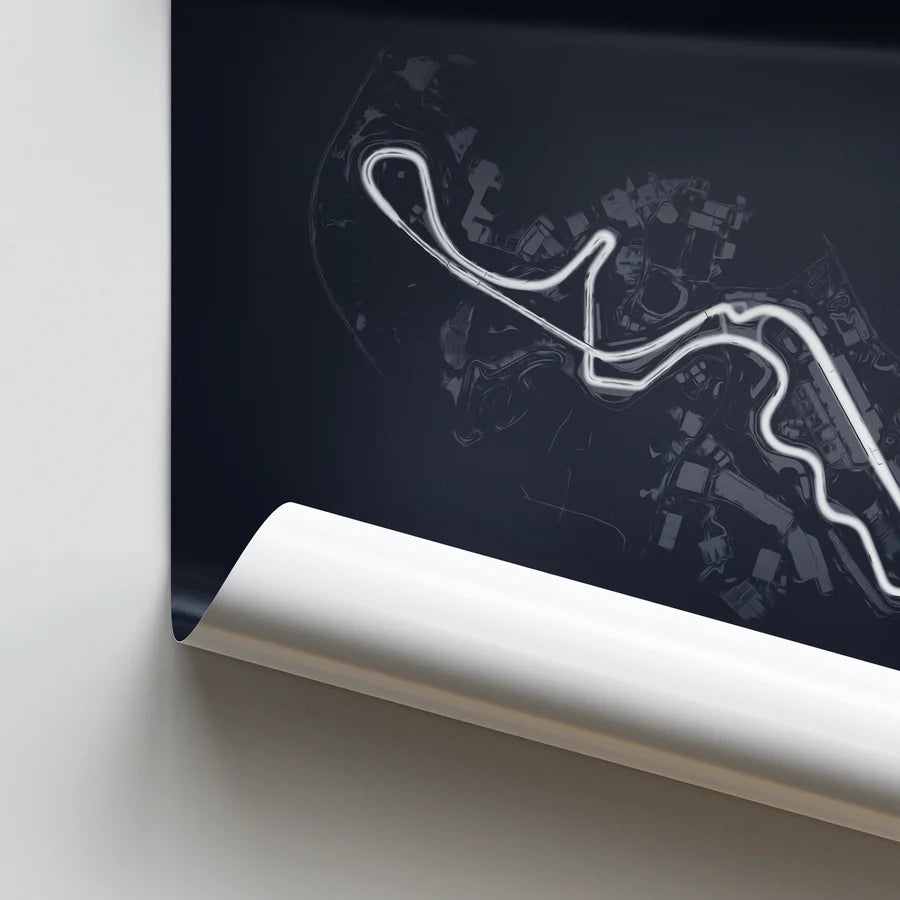 Roll of paper with a white outline of a race track design on a dark background